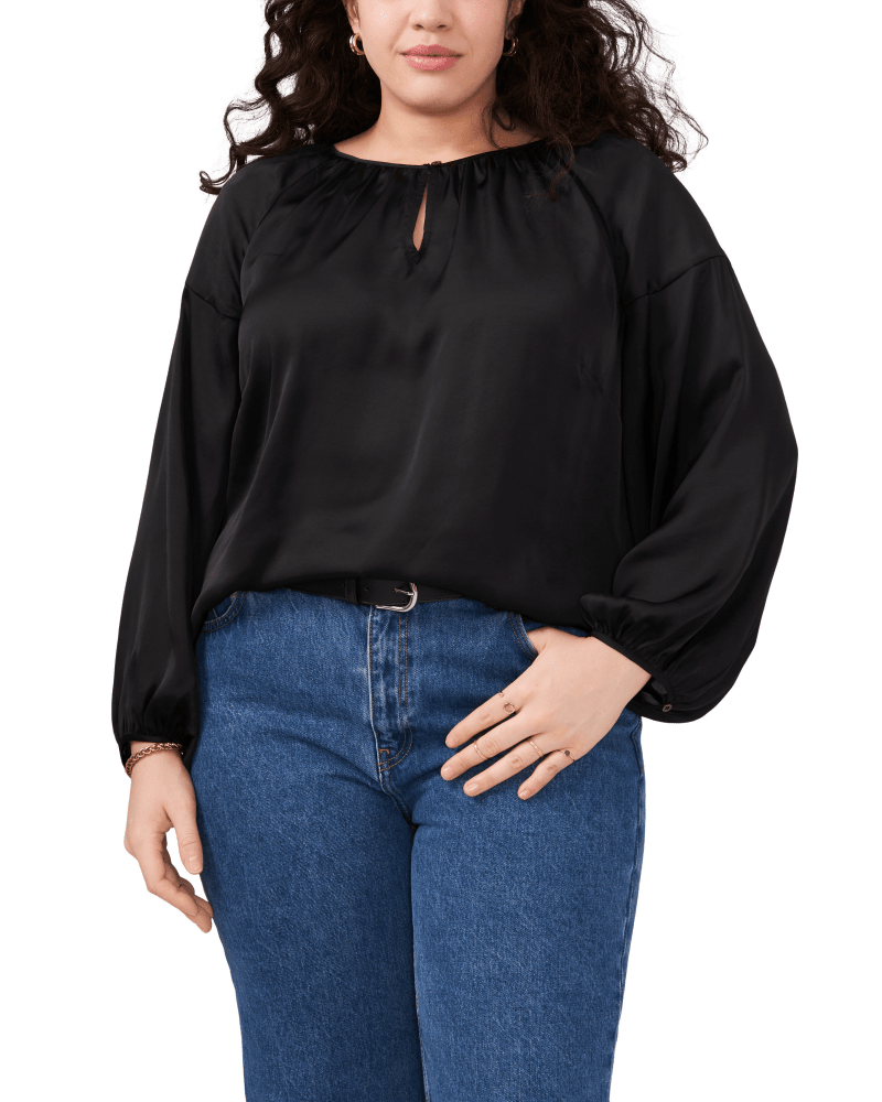 Front of a model wearing a size 1X Aria Peasant Blouse in RICH BLACK by Vince Camuto. | dia_product_style_image_id:261508